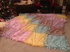 a blanket is laying on the floor next to a christmas tree