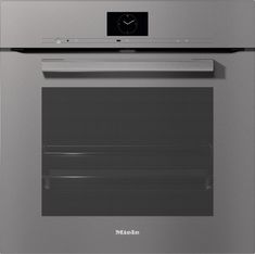 a stainless steel oven with the door open and clock on it's front panel