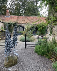 an outdoor garden with stone and metal sculptures