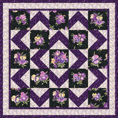 a purple and white quilt with flowers on the front, along with an argyle border