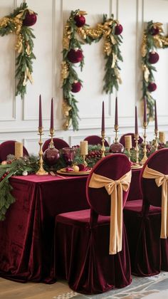 the table is set up with red velvet chairs and gold candlesticks for an elegant christmas dinner