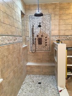 a walk in shower sitting inside of a bathroom