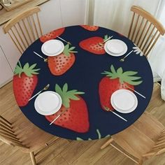 there is a table with strawberries on it and plates in front of the table