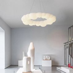 a large white sculpture sitting on top of a table next to a tall light fixture