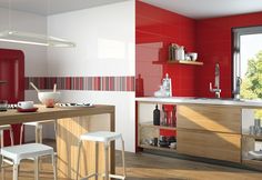 a modern kitchen with red and white walls