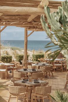 an outdoor dining area with wicker tables and chairs