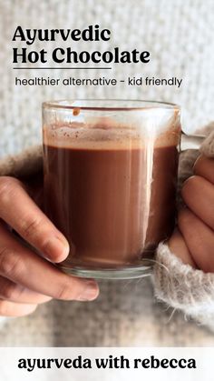 someone holding a cup of hot chocolate in their hands with the caption, ayurveda with rebreca