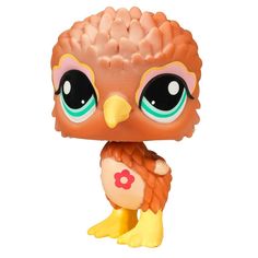 an orange and pink owl with big eyes sitting on top of a yellow bird figurine