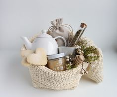 a knitted basket filled with tea and other items