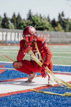 a lacrosse player squatting down on the field