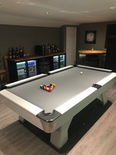 a pool table in the middle of a living room