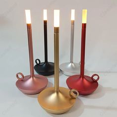 three different colored candles sitting next to each other