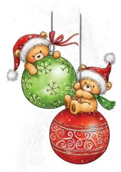 two teddy bears sitting on top of christmas ornaments