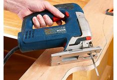 a person using a power tool on a piece of wood