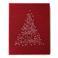 a red christmas card with a white tree on it