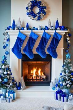 a fireplace decorated with blue and silver christmas stockings