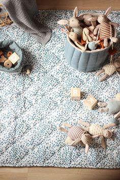 some toys are laying on a blue and white blanket