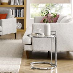 a living room scene with focus on the sofa and coffee table in the foreground