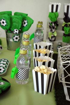 a table topped with lots of cupcakes and snacks