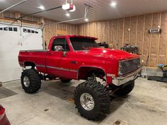 a large red truck parked in a garage