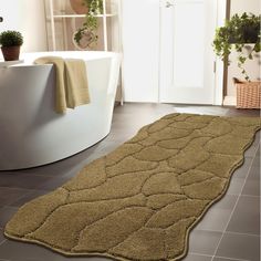 a bathroom with a bathtub and rug on the floor