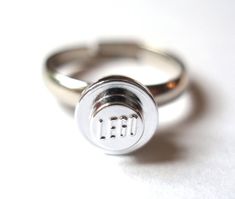 This is a cute little ring handmade using a Chromed Silver LEGO® stud attached to a silver plated adjustable ring. This would make a great substitute engagement ring to use to pop the question before you buy the real thing. The ring is adjustable so will fit most ring fingers.I've also made some gift / display boxes out of LEGO® bricks (3rd pic) if you want to keep your ring safe or are giving the ring as a present they are $6.95 each and postage is combined when bought with a ring, so please ch Lego Wedding, Mode Hippie, Chrome Silver, Dope Jewelry, Funky Jewelry, Ring Engagement, Jewelry Inspo, Dream Jewelry, Ring Wedding