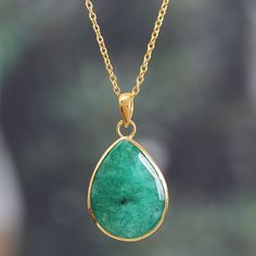 Flaunt your refined taste with this breathtaking pendant necklace, a sophisticated statement piece made for turning heads. The 17-carat beryl gemstone demands to be admired, its rich green hue seemingly plucked from a lush rainforest. Indian artisan Neetu Barathi's precious creation balances the stone's grandeur with a radiant 18k gold-plated adjustable cable chain designed to catch the light at every turn. Luxury Pear-shaped Emerald Gemstone Necklace, Formal Drop Emerald Gemstone Necklace, Elegant Emerald Teardrop Pendant Necklace, Luxury Green Pear-shaped Emerald Necklace, Formal Teardrop Emerald Pendant Necklace, Luxury Green Emerald Oval Pendant Necklace, Luxury Green Teardrop Pendant Necklace, Emerald Drop Gemstone Necklace, Luxury Teardrop Emerald Necklace Gift