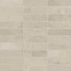 a white tile wall that has been made out of different types of marble tiles on it