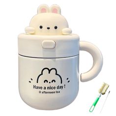 a white cup with an animal on it and a toothbrush in front of it