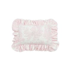 a pink pillow with ruffled edges and embroidered monogrammed letters on the front