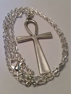 "Antique Silver Ankh Cross on a Silver Plated 24\" Chain. *Cross is 2\" Long and 1 1/8\" Wide Ankh is lightweight and comfortable to wear . May Choose Chain Length during checkout; 20\" 22\" 24\" Ankh Cross; The Ankh is also known as key of life, the key of the Nile or crux ansata (Latin meaning \"cross with a handle\"), was the ancient Egyptian hieroglyphic character that read \"eternal life\". Egyptian gods are often portrayed carrying it by its loop, or bearing one in each hand, arms crossed Ancient Egyptian Hieroglyphics, Egyptian Cross, Key Of Life, Ankh Necklace, Ankh Cross, Cross Symbol, Egyptian Hieroglyphics, Egyptian Symbols, Symbol Necklace