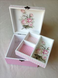 two open boxes with pink flowers painted on the sides and polka dots in the bottom