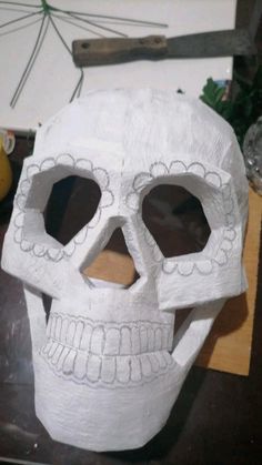 a paper mache skull sitting on top of a table