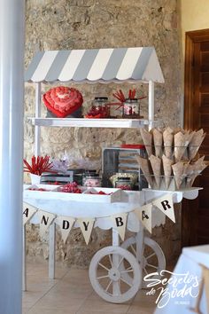 a table that has some food on it with bunting and flags hanging from the top