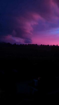 the sky is purple and blue as it appears to be overcast with dark clouds