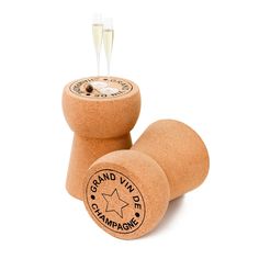 two cork wine stoppers sitting next to each other