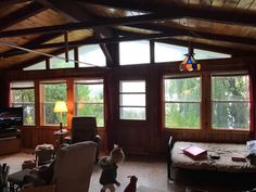 a living room filled with furniture and lots of windows