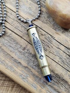 Stunning rifle casing embellished with a highly detailed filigree stamping. Blue sapphire beads are used in place of bullet and at the top, wire wrapped and secured. Hung from a generous 34 inch stainless steel ball chain. We use rifle calibers like 308, 30-30, 7mm and 303 British for this necklace which have an opening to fit the faceted beads. You will receive one of those! Sapphire is the birthstone of September, symbolic for beauty, prosperity and intuition.