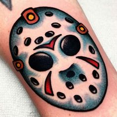 a tattoo on the leg of a person with a hockey mask