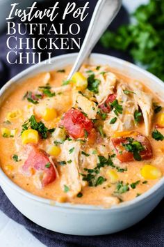 instant pot buffalo chicken chili in a white bowl with a spoon and parsley on the side