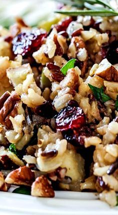 a close up of a plate of food with nuts and cranberries on it