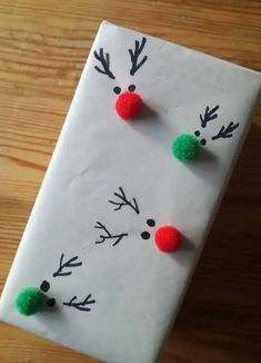 a piece of paper that has been made to look like reindeers with pom - poms