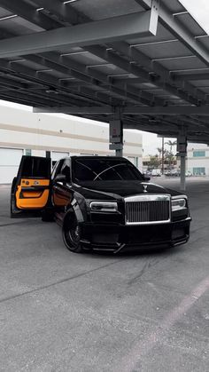 two rolls royces are parked in an empty parking lot