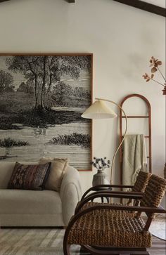 a living room filled with furniture and a painting on the wall