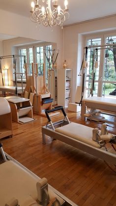 a room filled with lots of furniture and windows next to a wooden flooring area