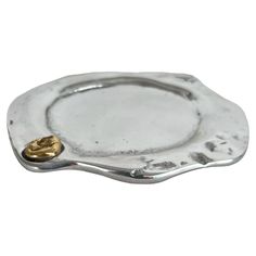 a silver plate with gold accents on it