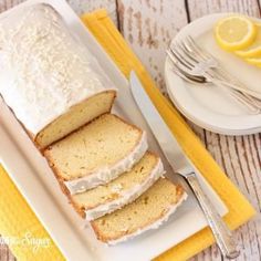 slices of lemon pound cake on a white platter with yellow napkins and silverware