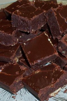 there are many pieces of brownies on the glass platter, ready to be eaten