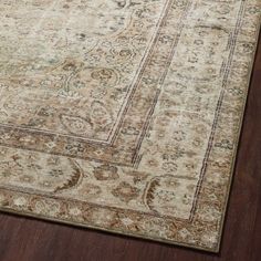 an antique style rug on a wooden floor