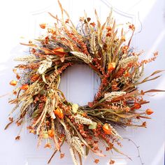 a dried wreath is hanging on the wall